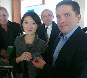 Brice Cruchon, CEO of DRACULA Technologies, showing the printed cells to the French minister, Fleur Pellerin.
